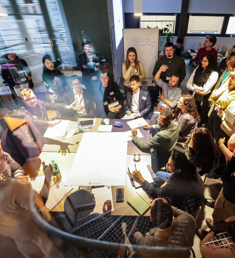 People gather around a table at an Aspen Institute event.